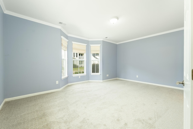 carpeted empty room featuring crown molding