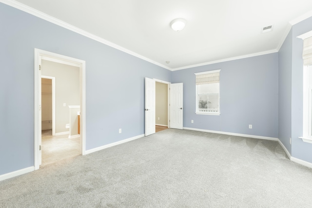 unfurnished bedroom featuring crown molding and light carpet