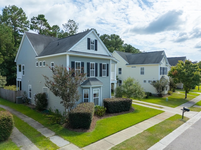 view of front facade with central AC and a front lawn