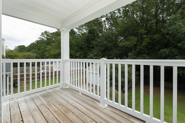 wooden deck featuring a lawn