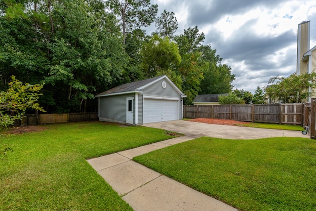 view of yard featuring a garage and an outbuilding