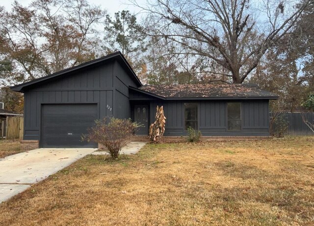 ranch-style house featuring a garage and a front yard