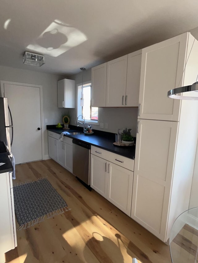 222 Braly Dr, Summerville, SC 29485 - kitchen featuring pendant lighting, sink, light hardwood / wood-style flooring, stainless steel appliances, and white cabinets