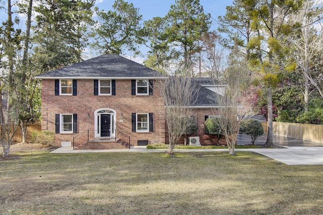 colonial home with a front lawn