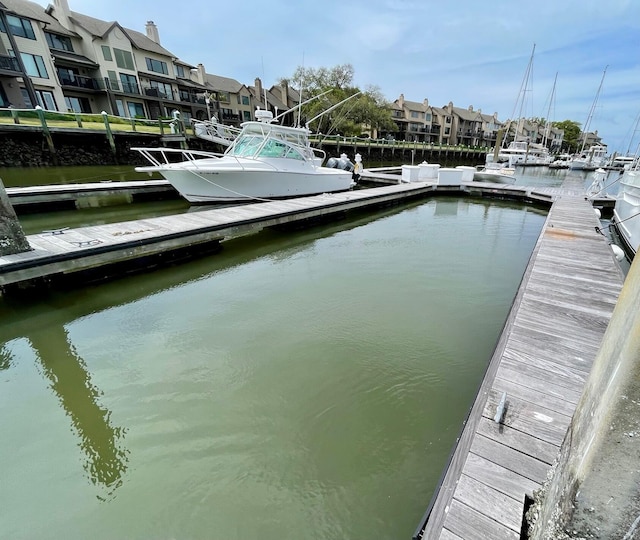dock area featuring a water view and a residential view