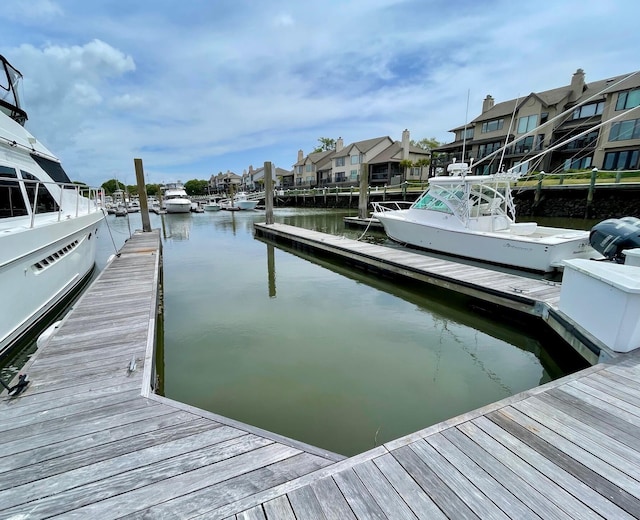 view of dock with a residential view and a water view