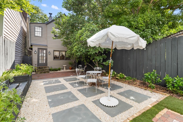 176 Smith St, Charleston, SC 29403 - fenced backyard featuring a patio area, outdoor dining area, and entry steps