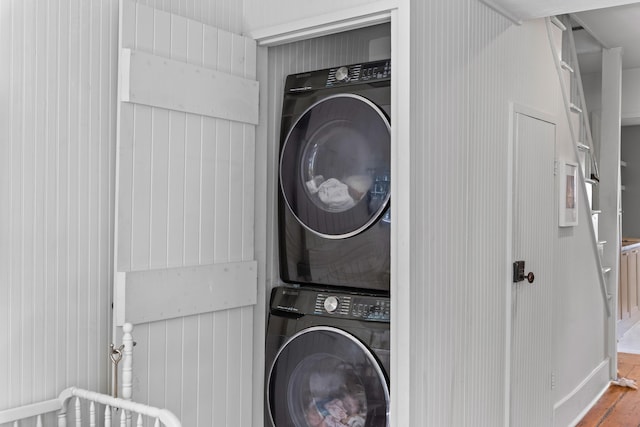 176 Smith St, Charleston, SC 29403 - laundry area with estacked washer and dryer and wood finished floors