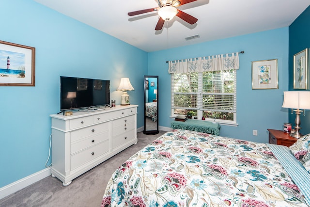 bedroom featuring light carpet and ceiling fan