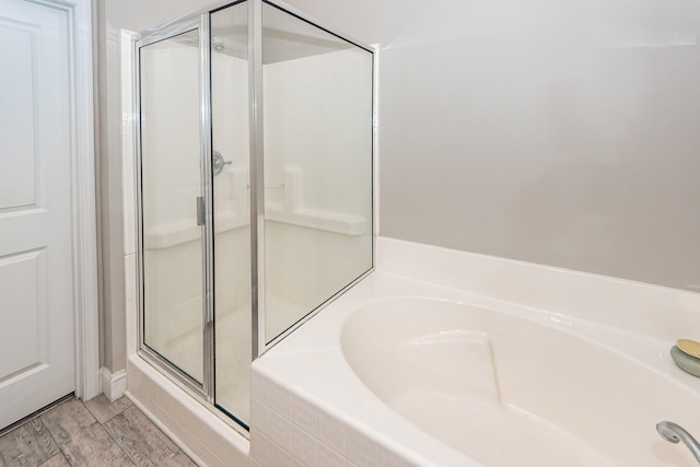 bathroom with wood-type flooring and separate shower and tub