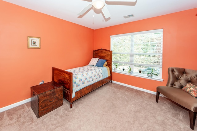 bedroom with light carpet and ceiling fan