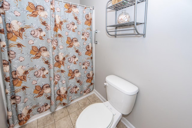 bathroom featuring toilet, walk in shower, and tile patterned flooring