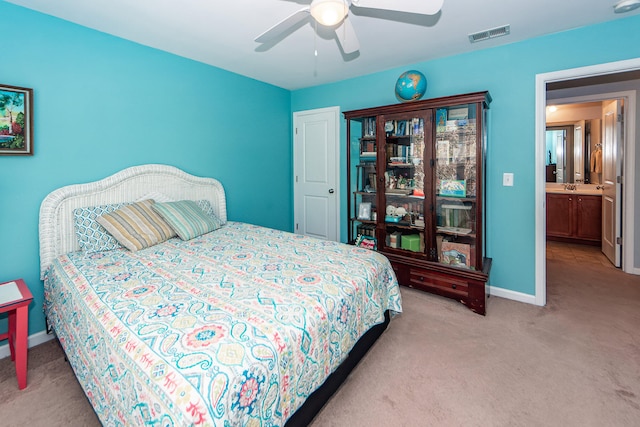 carpeted bedroom featuring ensuite bathroom and ceiling fan