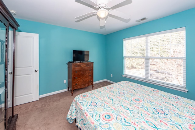 bedroom featuring light carpet and ceiling fan