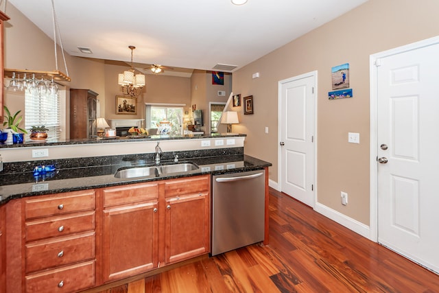 kitchen featuring sink, dark stone countertops, dishwasher, and dark hardwood / wood-style floors