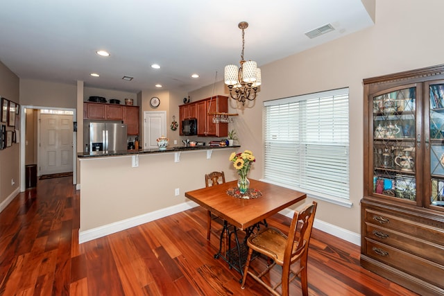 dining room featuring dark hardwood / wood-style flooring and a chandelier