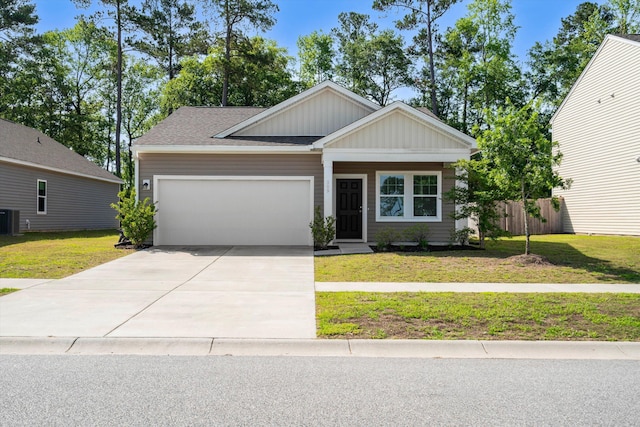 309 Sedona Dr, Summerville, SC 29486 - view of front of house with board and batten siding, an attached garage, concrete driveway, central AC, and roof with shingles