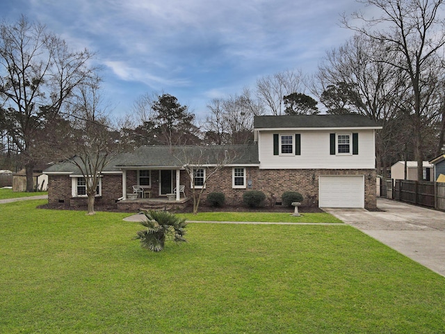 split level home with a porch, brick siding, fence, concrete driveway, and a front lawn