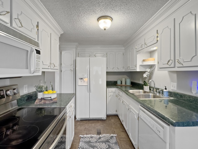 kitchen with white appliances, dark countertops, a textured ceiling, white cabinetry, and a sink