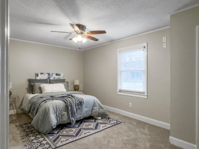 bedroom featuring ceiling fan, a textured ceiling, light colored carpet, baseboards, and ornamental molding