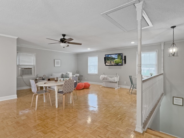 dining space featuring attic access, crown molding, a textured ceiling, and baseboards