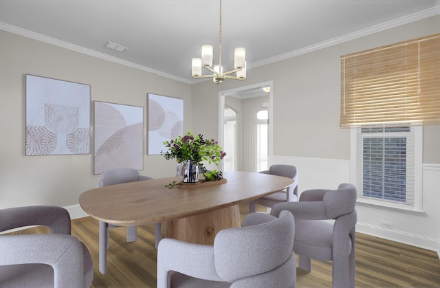 dining space featuring an inviting chandelier, dark wood-type flooring, and ornamental molding