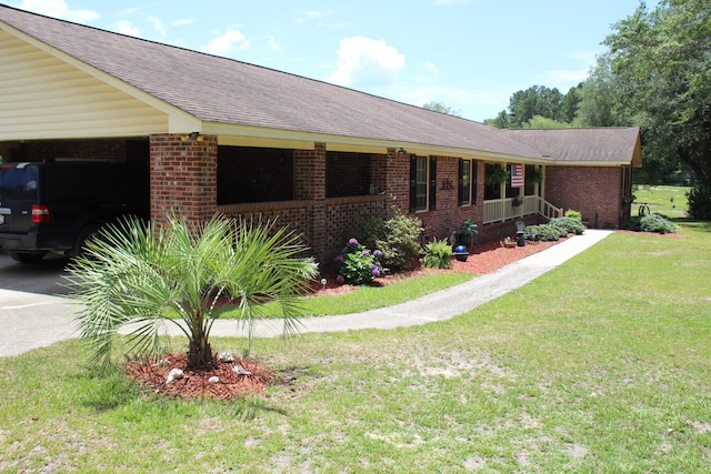 single story home featuring a carport, covered porch, and a front lawn