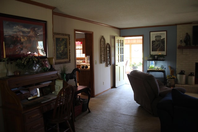 living room with a textured ceiling, ceiling fan, crown molding, and light carpet