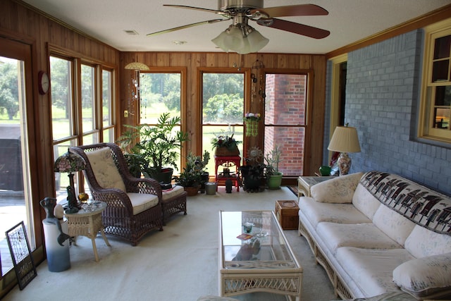 carpeted dining room featuring a chandelier, a textured ceiling, crown molding, and wood walls