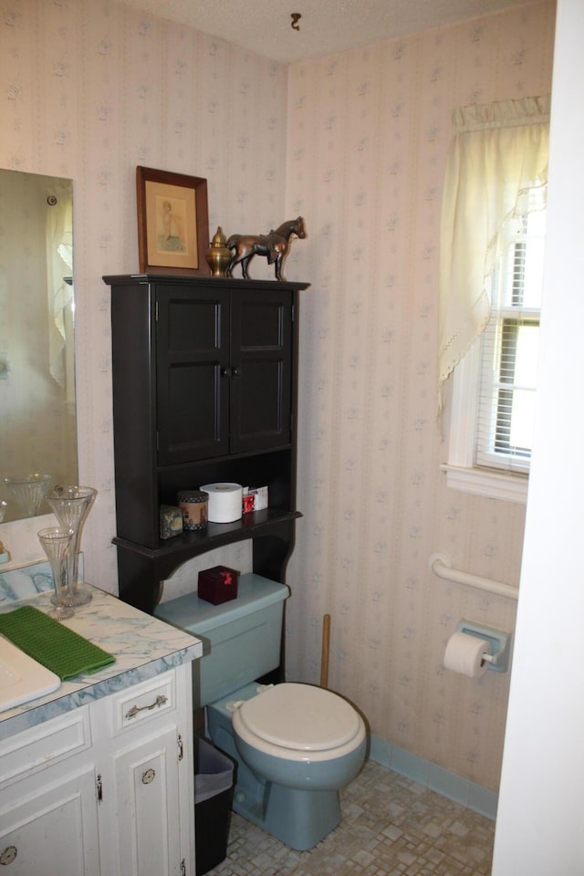 bathroom with tile patterned floors, vanity, and toilet