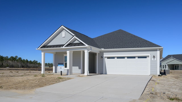 view of front facade featuring a porch and a garage