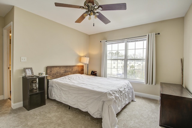 bedroom with ceiling fan and light carpet