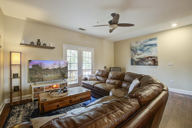 living room featuring dark hardwood / wood-style flooring and ceiling fan