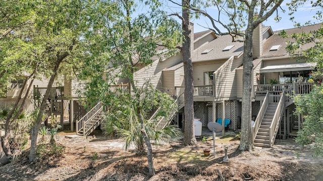166 River Breeze Dr, Charleston, SC 29407 - back of property with stairway, a wooden deck, and a shingled roof