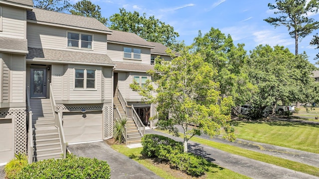 166 River Breeze Dr, Charleston, SC 29407 - view of front of house with an attached garage, stairway, roof with shingles, driveway, and a front yard