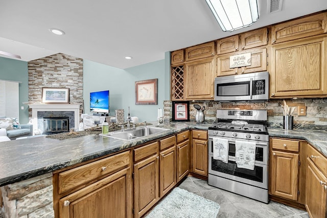 166 River Breeze Dr, Charleston, SC 29407 - kitchen with appliances with stainless steel finishes, vaulted ceiling, a sink, backsplash, and dark countertops