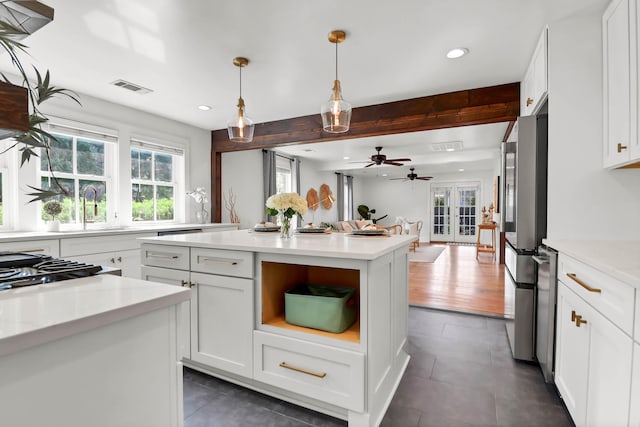 1151 Camellia Dr, Mount Pleasant, SC 29464 - kitchen with recessed lighting, a center island, dark tile patterned flooring, white cabinetry, and a sink