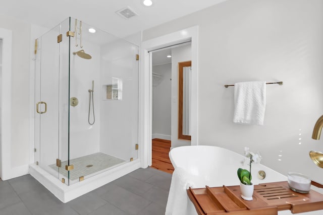 1151 Camellia Dr, Mount Pleasant, SC 29464 - bathroom with a shower stall, tile patterned floors, a freestanding bath, recessed lighting, and a spacious closet