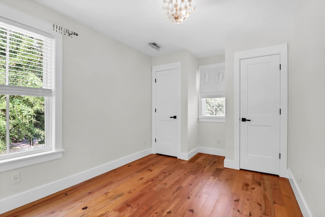 1151 Camellia Dr, Mount Pleasant, SC 29464 - unfurnished room with light wood-style floors, baseboards, and a chandelier