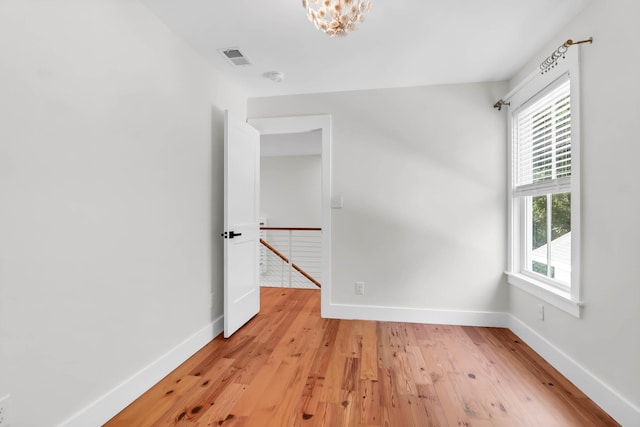 1151 Camellia Dr, Mount Pleasant, SC 29464 - empty room featuring baseboards, light wood-type flooring, and a chandelier