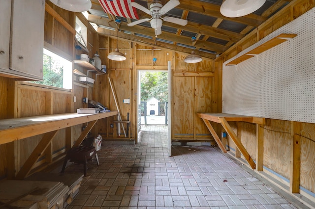 1151 Camellia Dr, Mount Pleasant, SC 29464 - misc room featuring a workshop area, wooden walls, ceiling fan, brick floors, and lofted ceiling