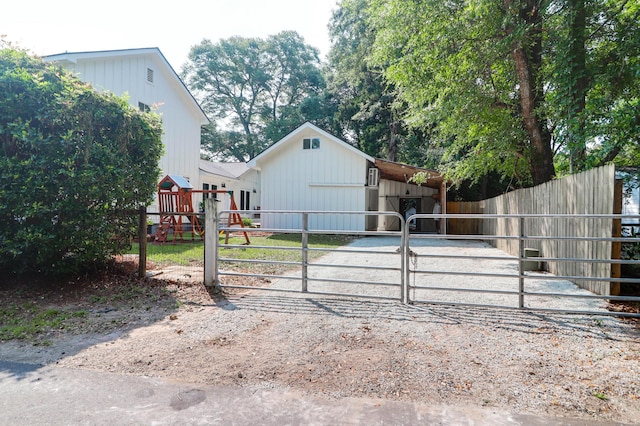 1151 Camellia Dr, Mount Pleasant, SC 29464 - view of front facade with a gate, a playground, and driveway
