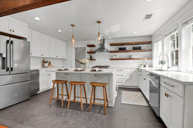 1151 Camellia Dr, Mount Pleasant, SC 29464 - kitchen with stainless steel appliances, open shelves, a center island, a sink, and tasteful backsplash
