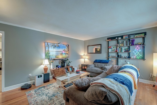 living room featuring light hardwood / wood-style flooring, ornamental molding, and a textured ceiling