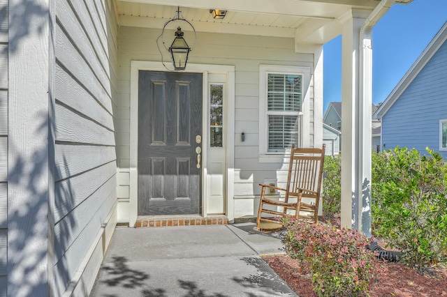 doorway to property featuring covered porch