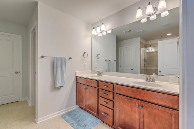 bathroom featuring double vanity, a sink, tile patterned flooring, and a stall shower