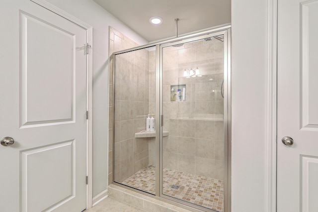bathroom featuring tile patterned flooring, a shower stall, and recessed lighting