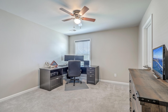 home office featuring ceiling fan, visible vents, light carpet, and baseboards