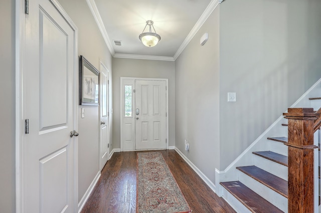 foyer entrance with visible vents, ornamental molding, wood finished floors, and stairway