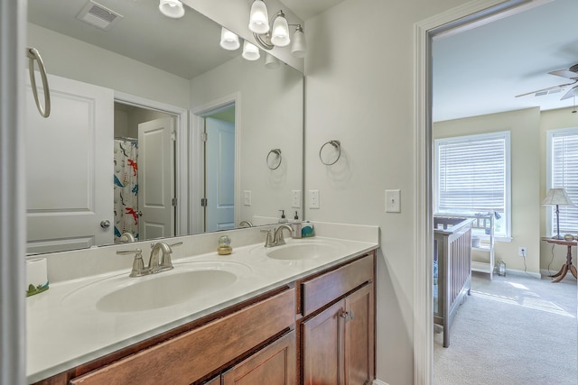 full bath featuring visible vents, a sink, baseboards, and a ceiling fan